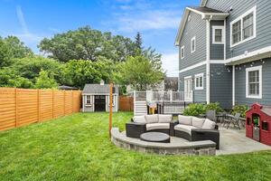 Plush grass backyard includes 10x8 Amish shed