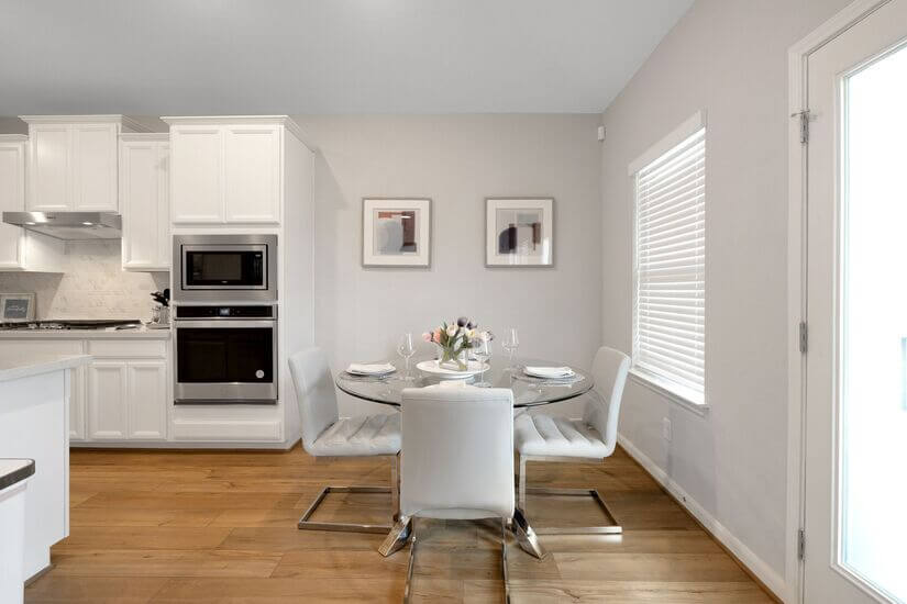 Cozy breakfast nook with natural light and modern seating.
