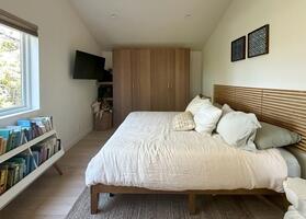 King bed, TV and nightstands.  Luxe