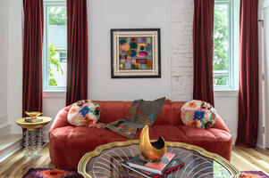 Red velvet seating adds bold glam to lounge