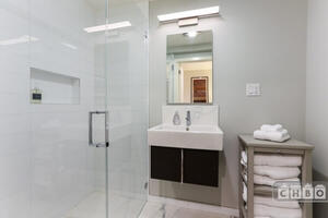 tiled bathroom with curbless lge shower with