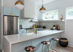 Modern kitchen with pendant lights & bar top