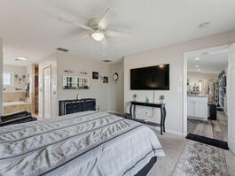 Primary Bedroom with TV and Ceiling Fan