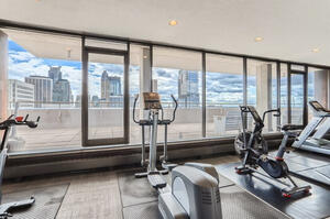 Cardio equipment overlooking the cityscape.