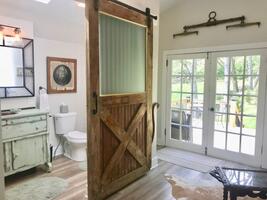 Full bathroom, sitting area, overlooking private back deck.