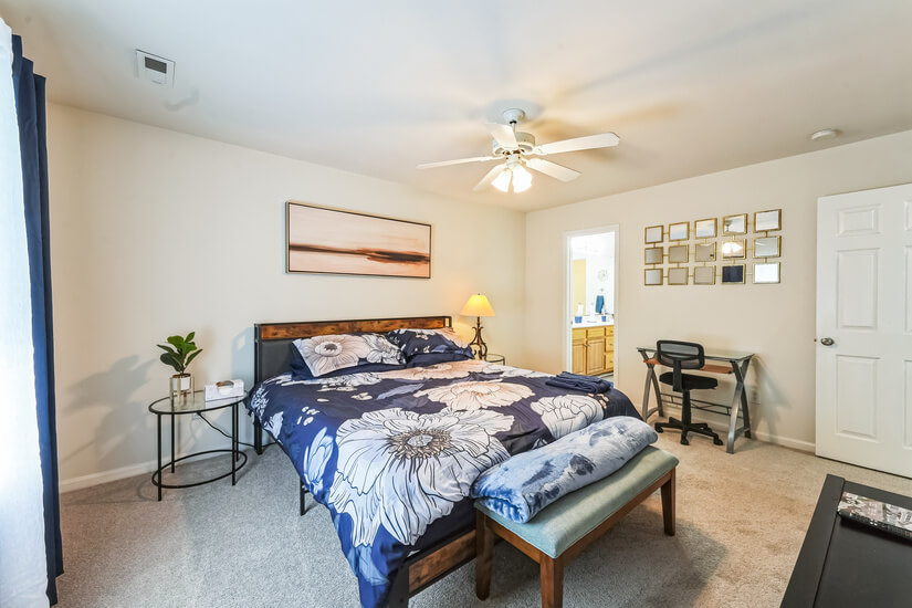 King  bed with connected bathroom with tub and shower.