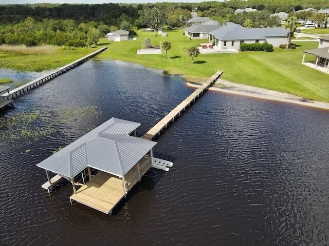 The dock has a boat lift, 3 jetski cradles, bench seating