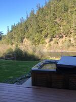Hot tub has a view of Rogue river.