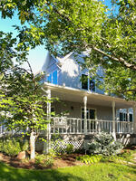 Front Exterior with mature trees and garden beds