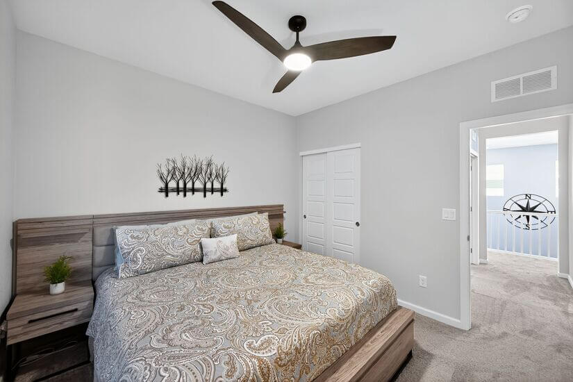 Upstairs guest room with ceiling fan