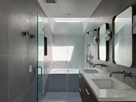 Glass enclosed walk-in shower.