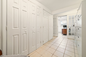 Storage Hallway with Closets and Access to Office