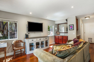 Family Room with Door Leading into Half Bathroom, Garage, &