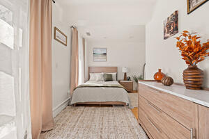 Bedroom with dresser and natural light