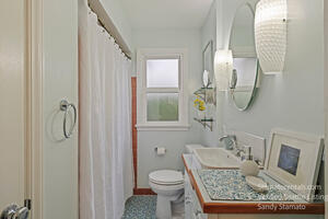 A newly remodeled bathroom. Lots of shelving and light