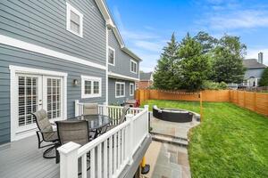 Backyard includes deck and white cedar fence