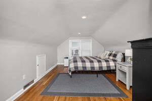 Upper bedroom with Queen bed, side table and dresser