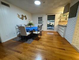 Dining room + screened in patio in background