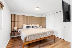 Clean comfortable bedroom with natural light