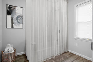 Full bathroom with tub and shower curtain