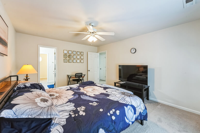 Primary bedroom with tv.