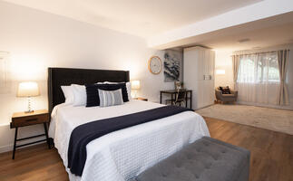 Downstairs bedroom with queen bed and full bed