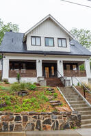 Charming front exterior with lush landscaping