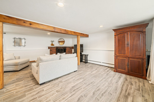 Family Room Wide View with Fireplace and Armoire