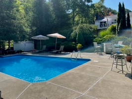 In-Ground Pool with Patio Seating and Lounge Area