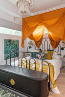 Bold double vanity bath with luxe gold drapes