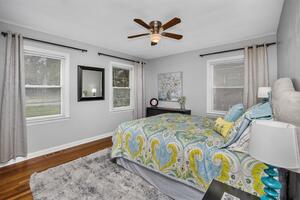 Main floor bedroom with nightstands, dresser & lamps