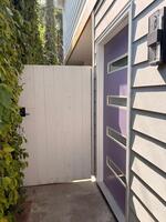 Ivy covered , lit walkway to the door