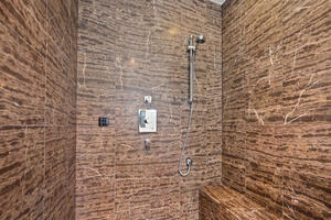 Walk-in shower with bench and handheld showerhead