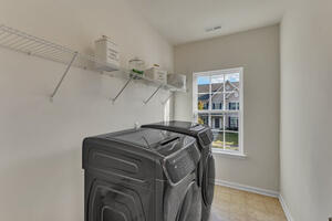Laundry room on upper floor w/ laundry sink