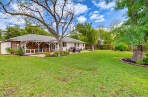 Spacious backyard with mature trees