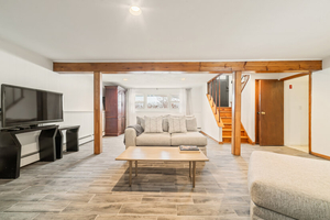 Family Room Centered View with Seating, TV, and Stair Access
