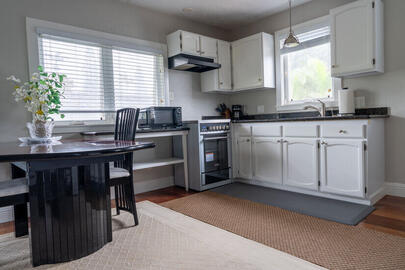 Open kitchen/dining w/fullsize refrigerator.