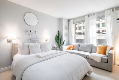 Cozy bedroom with comfy mattress and a couch